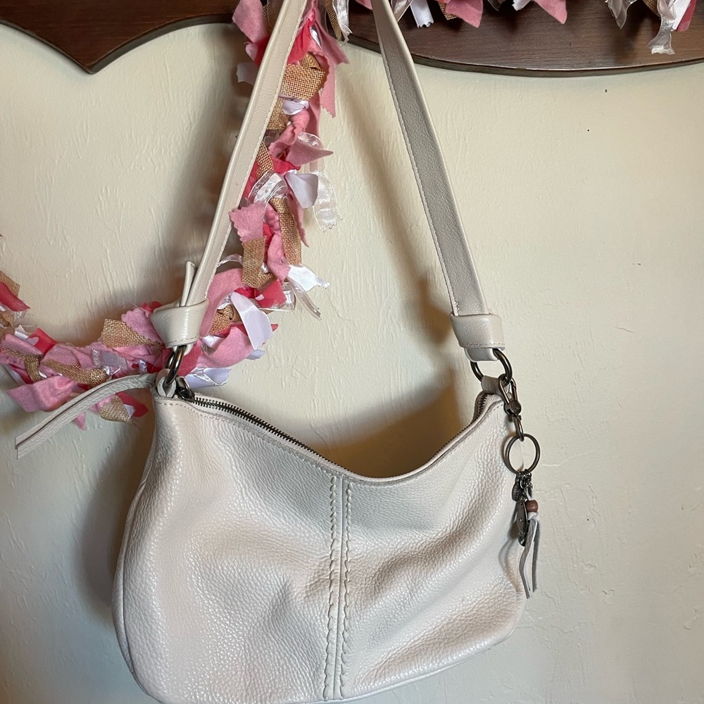The Sak Cream Shoulder Bag with Adjustable Strap and Silver Hardware